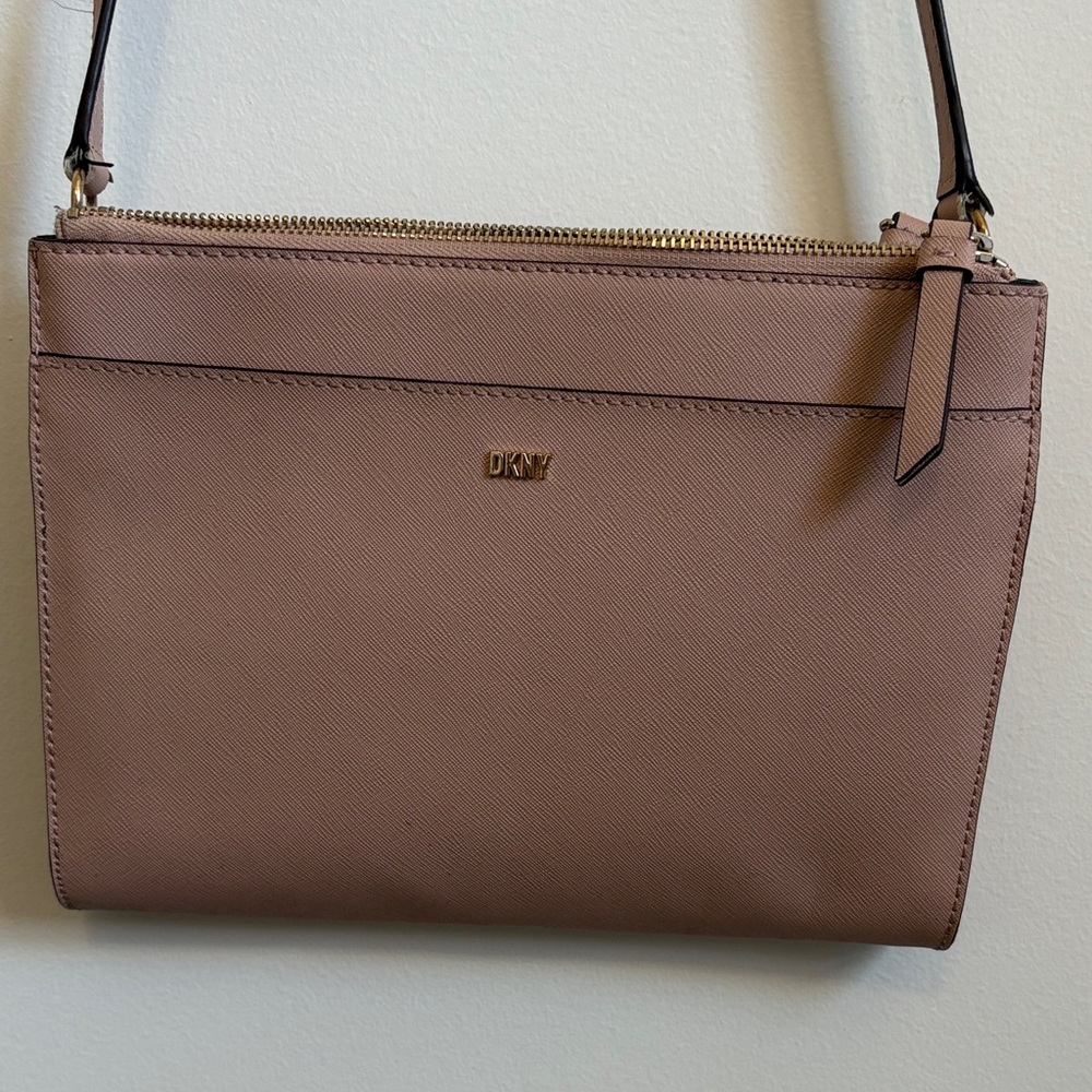 DKNY women's crossbody bag in a pale pink/blush color.